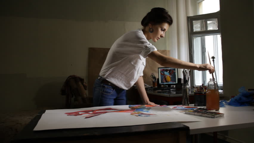 Woman artist painting watercolor paints