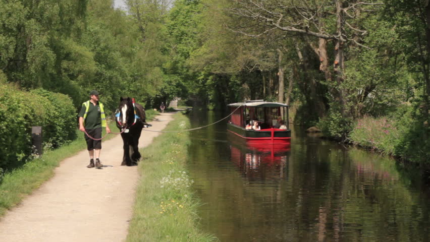 LLANGOLLEN, DENBIGHSHIRE/WALES - MAY 23: Unidentified tourists travel on a horse drawn boat along the Llangollen canal on May 23, 2012 in Llangollen. This is the traditional way canal boats moved.
