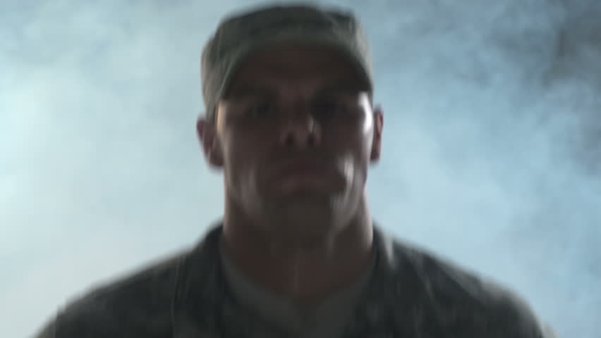 Soldier running, smoke in background