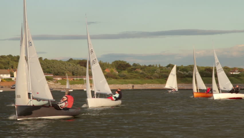 WEST KIRBY, WIRRAL/ENGLAND - JULY 11: Unidentified people race dinghies on lake on July 11, 2012 in Wirral. The Marine Lake is a man made coastal lake fed by the sea at high tide