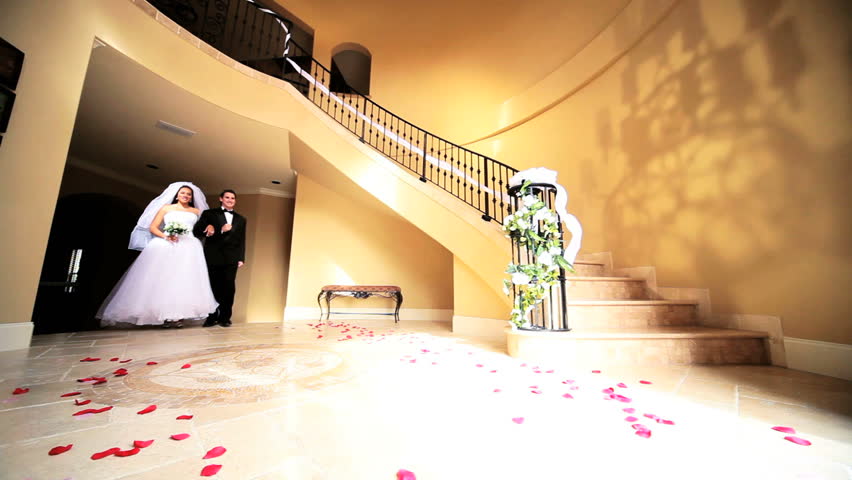 Bride and groom formal wedding attire walking hallway elegant luxury home