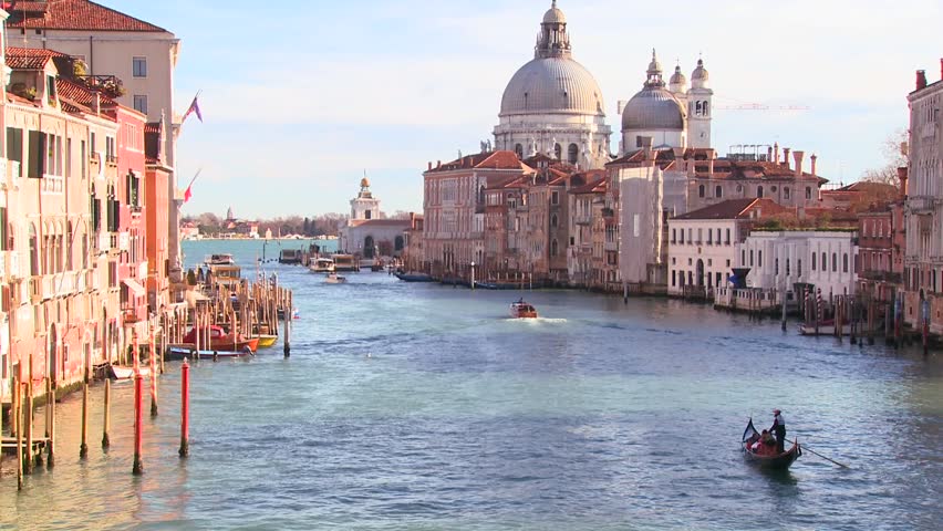 VENICE, ITALY-CIRCA 2011-A gondolier rows and we reveal a beautiful canal in Venice, Italy.