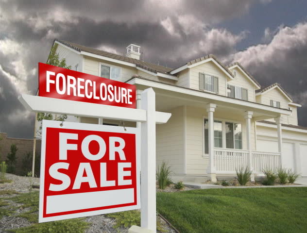 Foreclosure For Sale Sign, Home and Ominous Time Lapse Clouds.