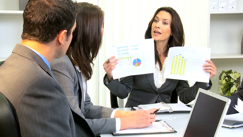 Young female Caucasian business executive chairing boardroom meeting business team