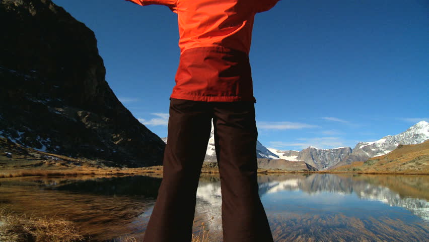 Young woman climbing to the mountain