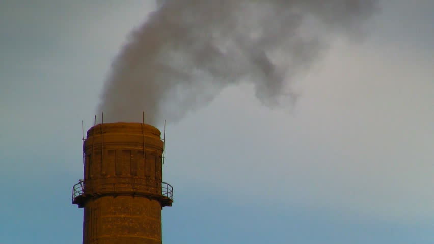 Gray smog coming from industrial chimney of heating plant polluting air