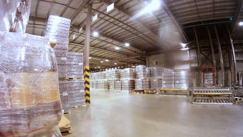 Loader transports containers with kvass in warehouse of nonalcoholic plant, time lapse