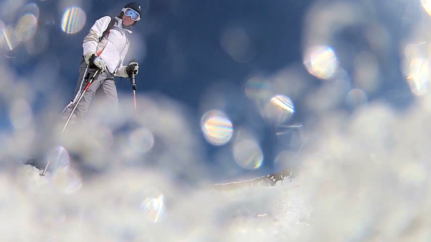 Downhill skier performing a maneuver on the slopes