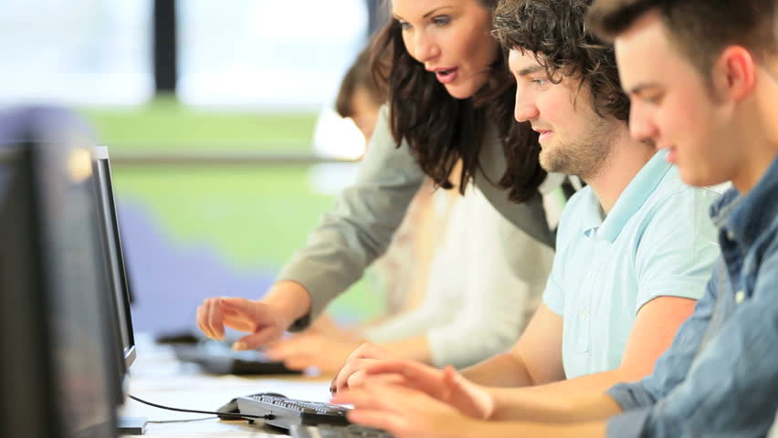 Caucasian female teacher instruct young college classmates researching knowledge in technology IT room