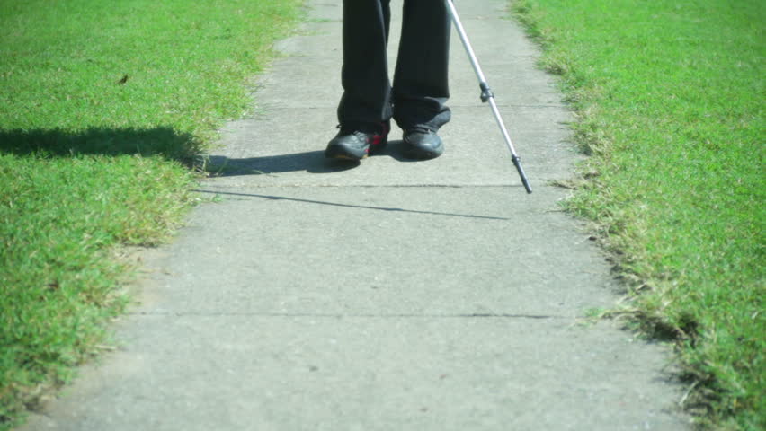 blind man walking with a stick