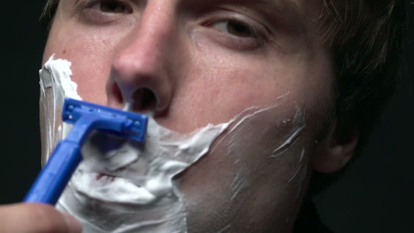 Close up of man shaving