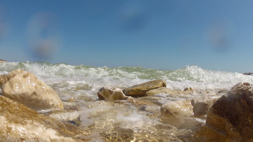 Sea waves hitting rocks on the coast.

