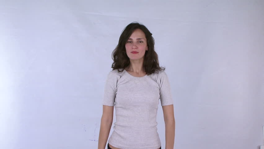 Young woman performing ballet elements in the studio.