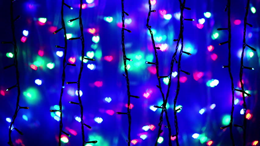 Illumination garland decoration blinking on heart shaped bokeh background