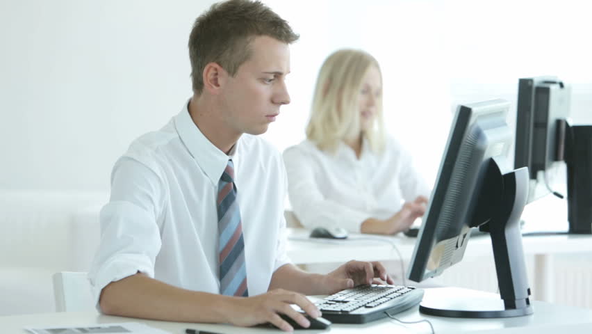 Young colleagues being busy working with digital and printed data