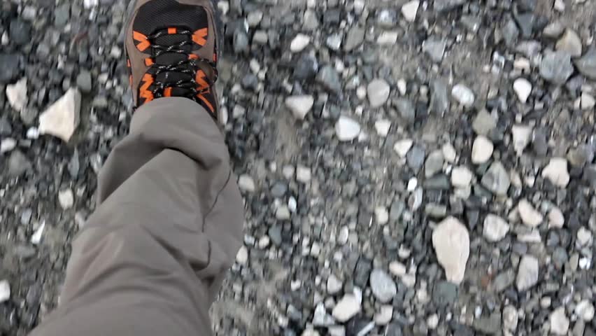 hiker walks a rocky trail