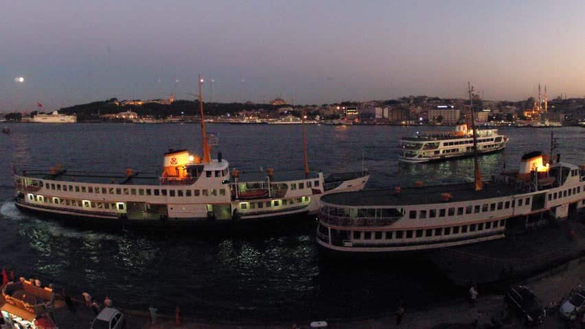 Walking ships float in bay Golden horn at coast of Istanbul in evening, time lapse