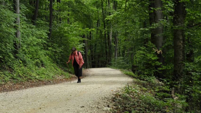 grandma is wandering on a forest track