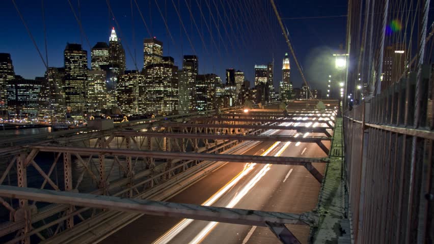 Time lapse of traffic on Brooklyn Bridge against the Manhattan skyline