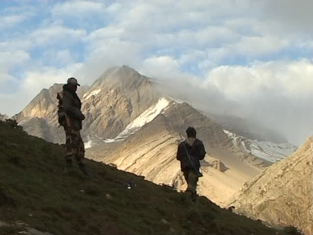 Soldiers with machine gun are on sentry duty in the Himalayas