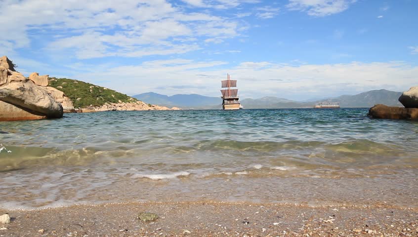Boat and rock near tropical island