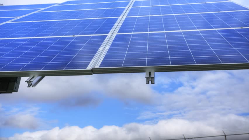 A dynamic timelapse moving by a solar panel as it moves to face the sun.