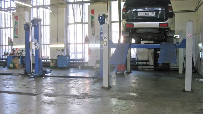 MOSCOW - AUG 22: (Timelapse View) Car lower from lifting-jack hoist in garage of service center Avtostandart, on Aug 22, 2012 in Moscow, Russia