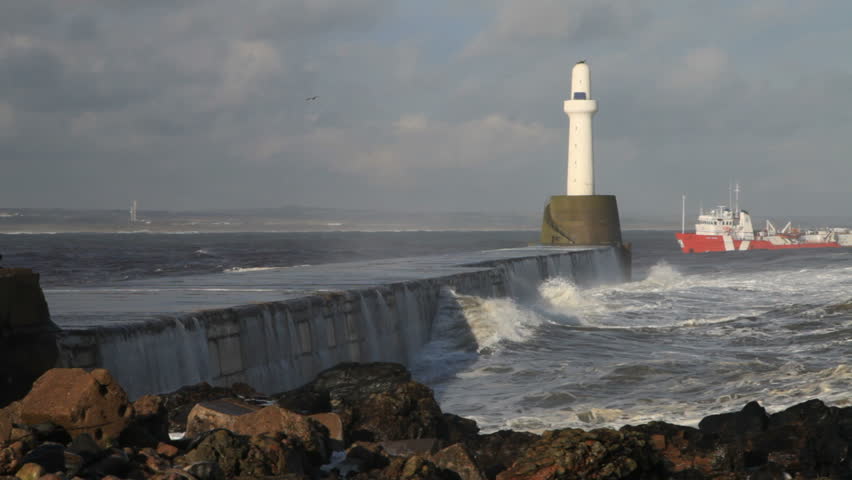 Oil support vessel entering Aberdeen harbour, Scotland, in heavy seas
