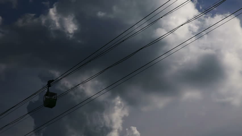 Moving cable cars with cloudy sky in Cologne, Germany
