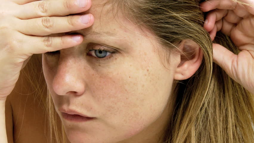 Beautiful blond woman with blue eyes strong expression of pain because of head ache
