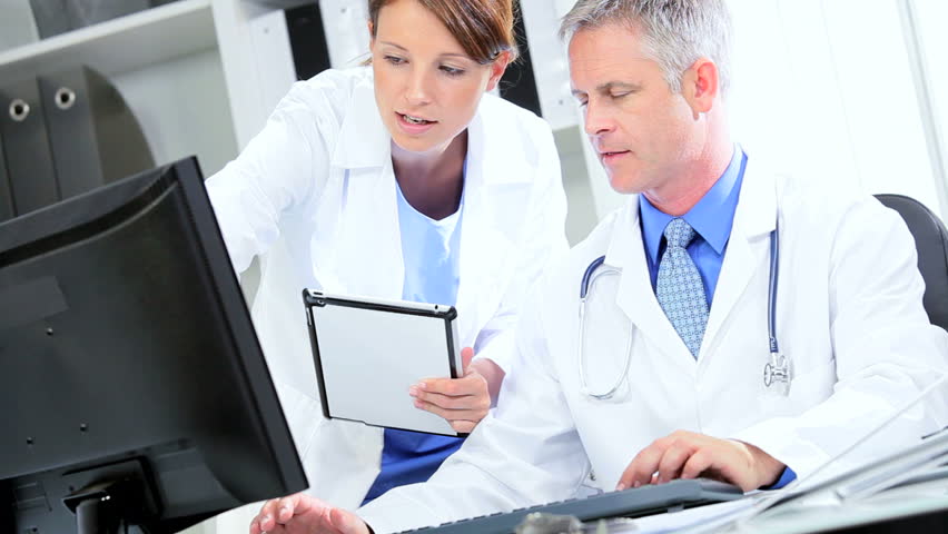 Hospital consultants using wireless tablet check patients test results