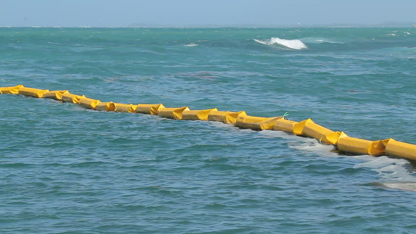 Oil slick contention barrier during environmental emergency.