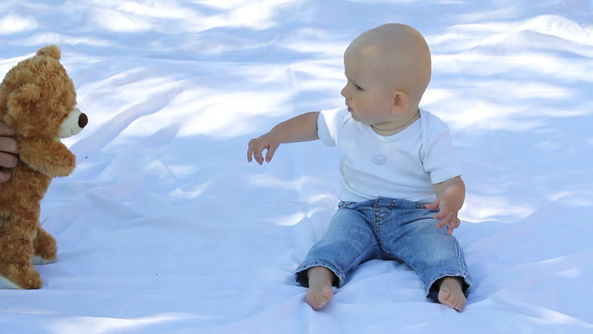 Baby having fun with his teddy bear toy