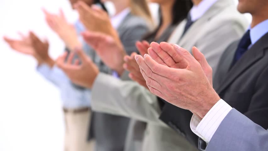 Close-up of hands applauding against a white background