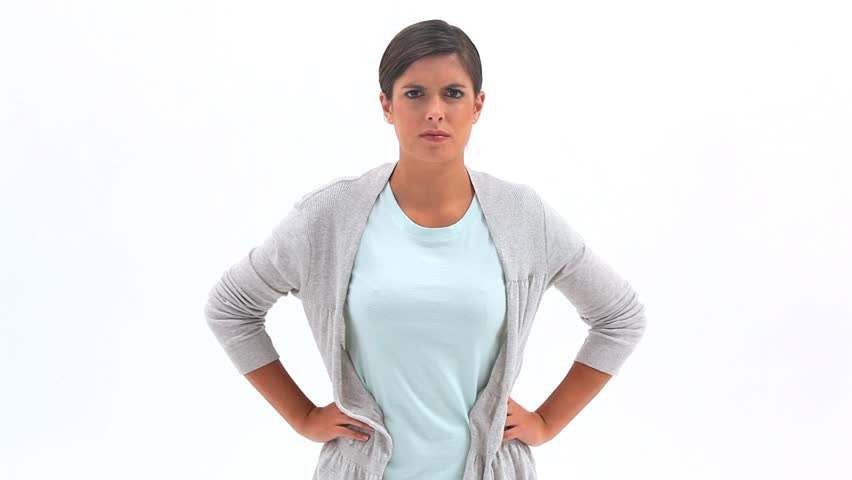 Angry woman with her hands on her hips against white background