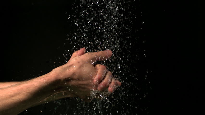 Hands washing under water slow motion on blakc background
