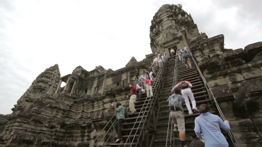 ANGKOR WAT - JUNE 2012: tourists climbing steps of Angkor Wat
