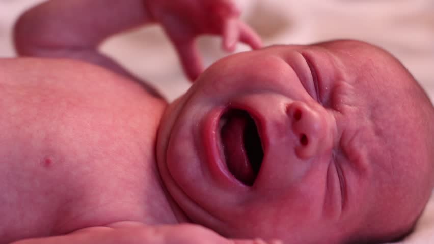 Baby sleeping crying in red and diaper