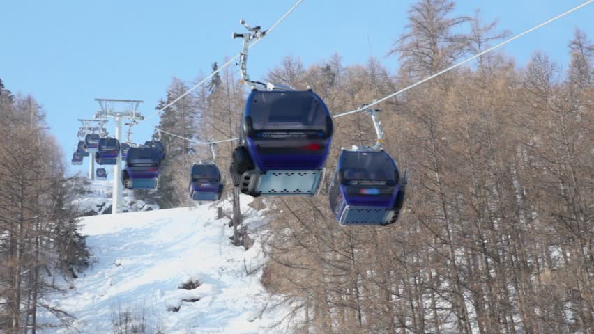 Cableway cabins ride above mountains in Austrian Alps