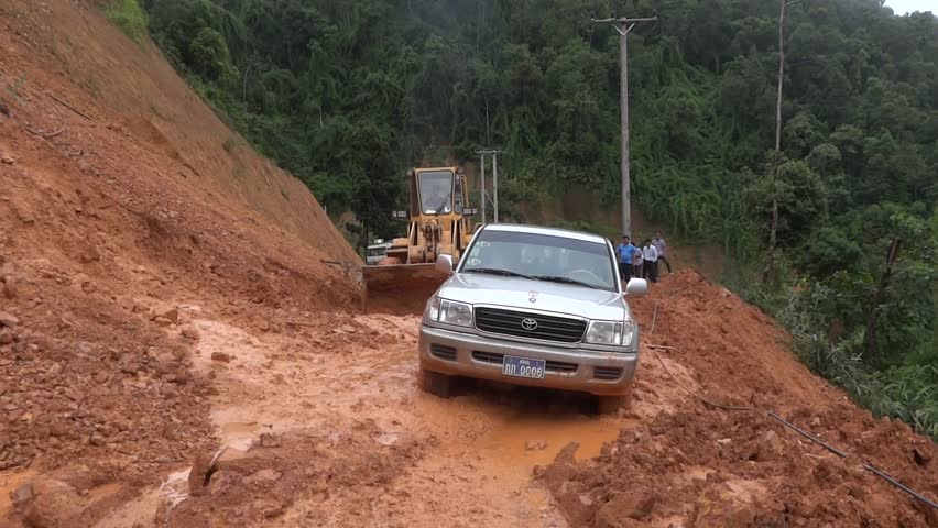 SOP HUN - AUGUST 14: Removal of land slide which caught a jeep by heavy machines August 14, 2012 in Sop Hun, Laos.