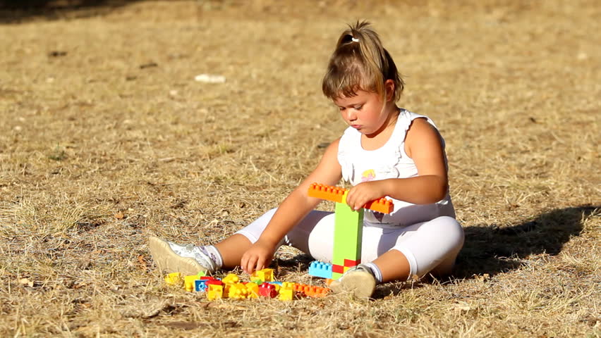 Kid and plastic bricks

Description: Little girl building a house with plastic bricks      
