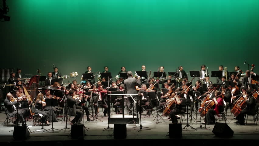 GUANAJUATO, MEXICO - CIRCA OCTOBER 2012: The Puebla symphonic orchestra playing on stage during the Cervantino festival circa October 2012 in Guanajuato, Mexico.