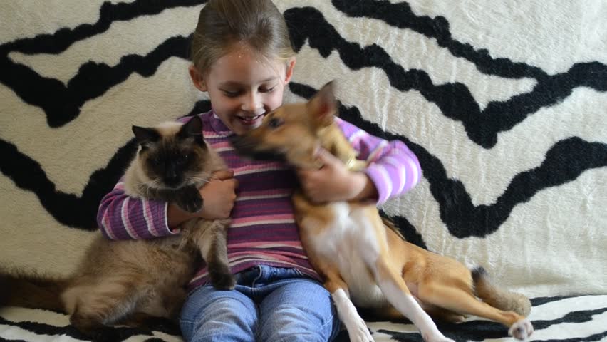little girl with a puppy and a kitten
