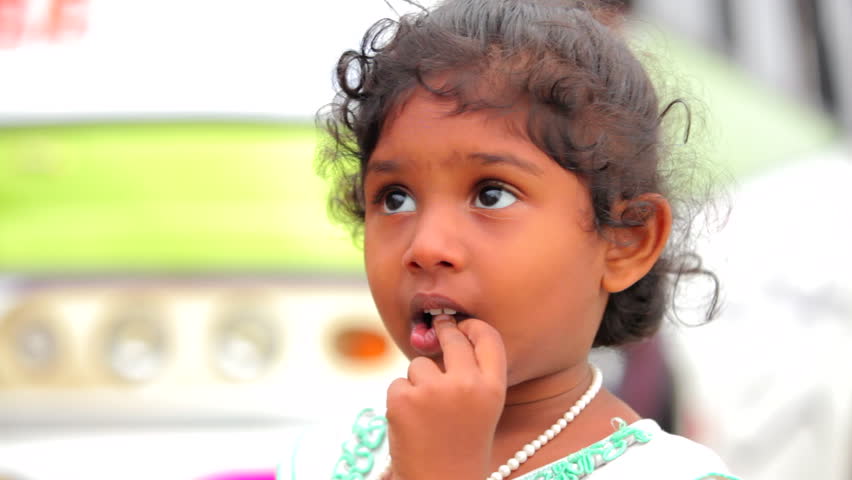 Cute Indian little girl in outdoor background.