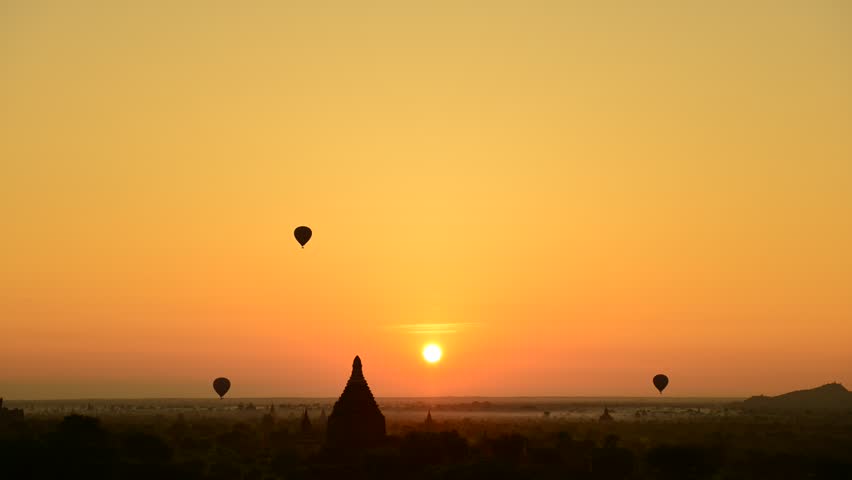 Hot air balloon and sunrise panorama view over temples of Bagan in Myanmar