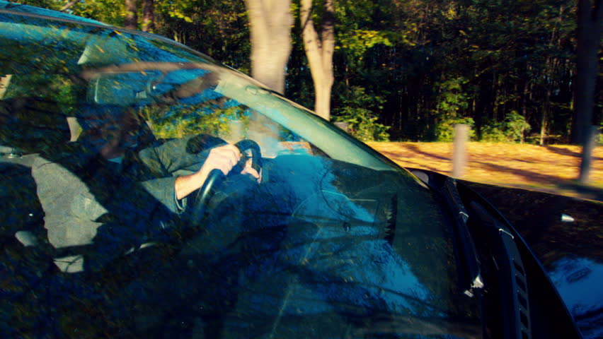 man inside the car, driving and steering