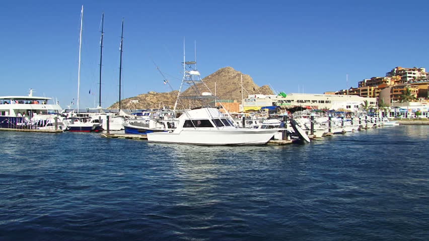 Cabo San Lucas, Mexico point of view while driving out of downtown harbor with many yachts and boats in marina.