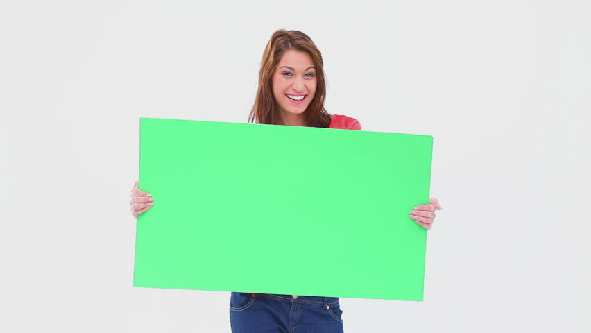 Brunette haired woman holding a blank poster against white background
