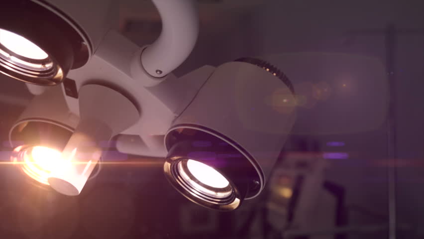 Detail of surgical lamp lit in empty operating room at clinic