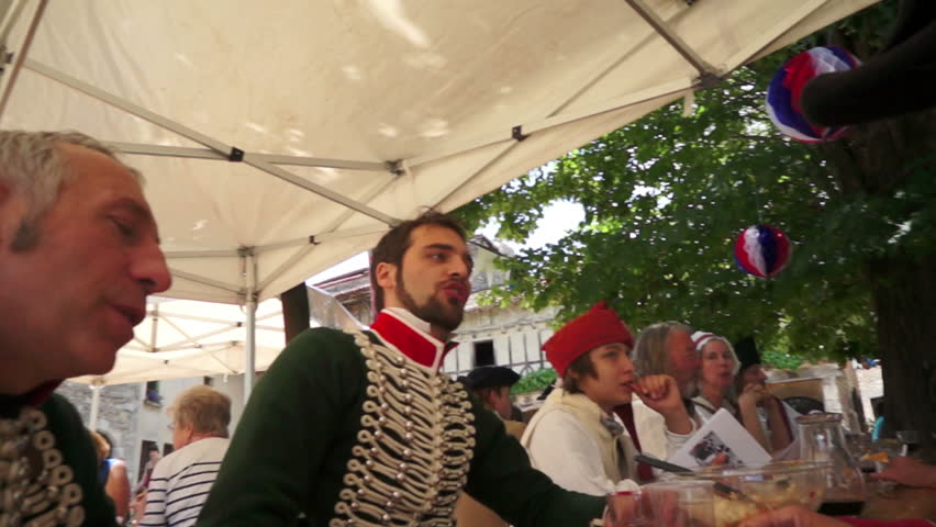 PEROUGES, FRANCE - JULY 14: People commemorate the French Revolution on July 14, 2012 in Perouges, France in an annual celebration by wearing historical costume and singing the popular songs of their ancestors.